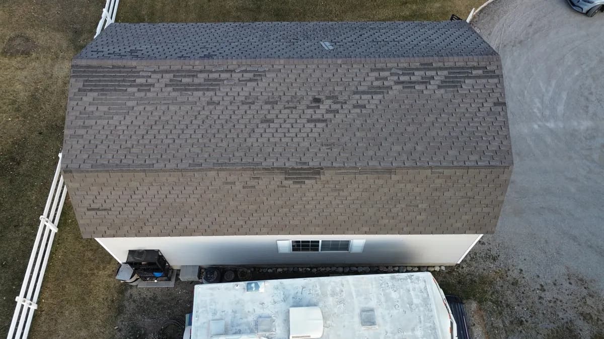 Residential roof damage area illustrating hidden conditions that affect leak repair costs