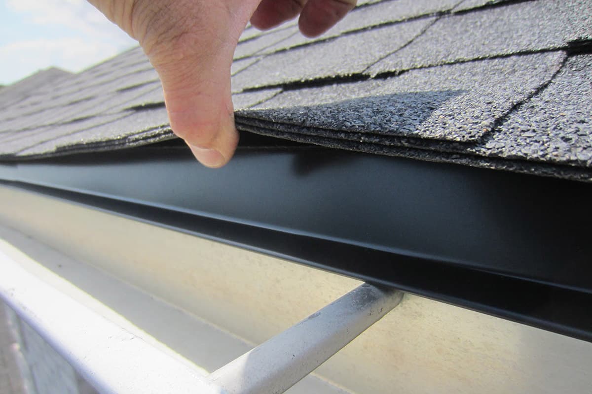 Close-up of drip edge installed beneath shingles at a roof edge