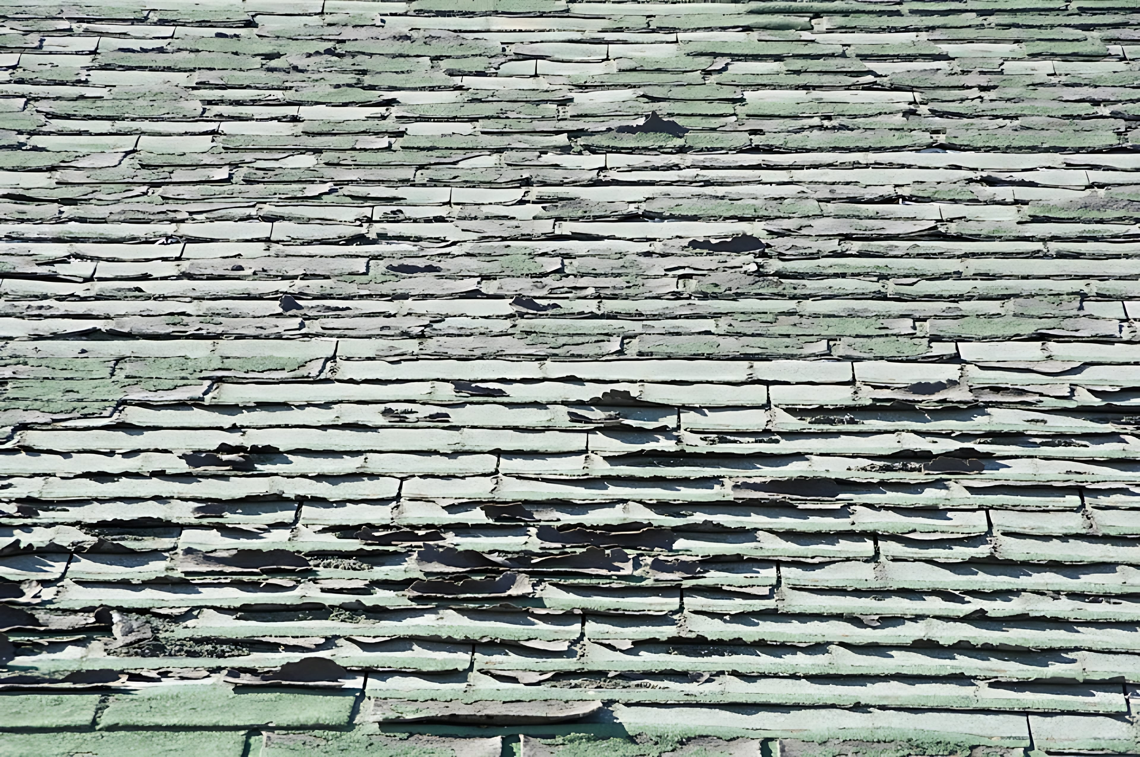 Missing asphalt shingles on a roof exposing underlayment