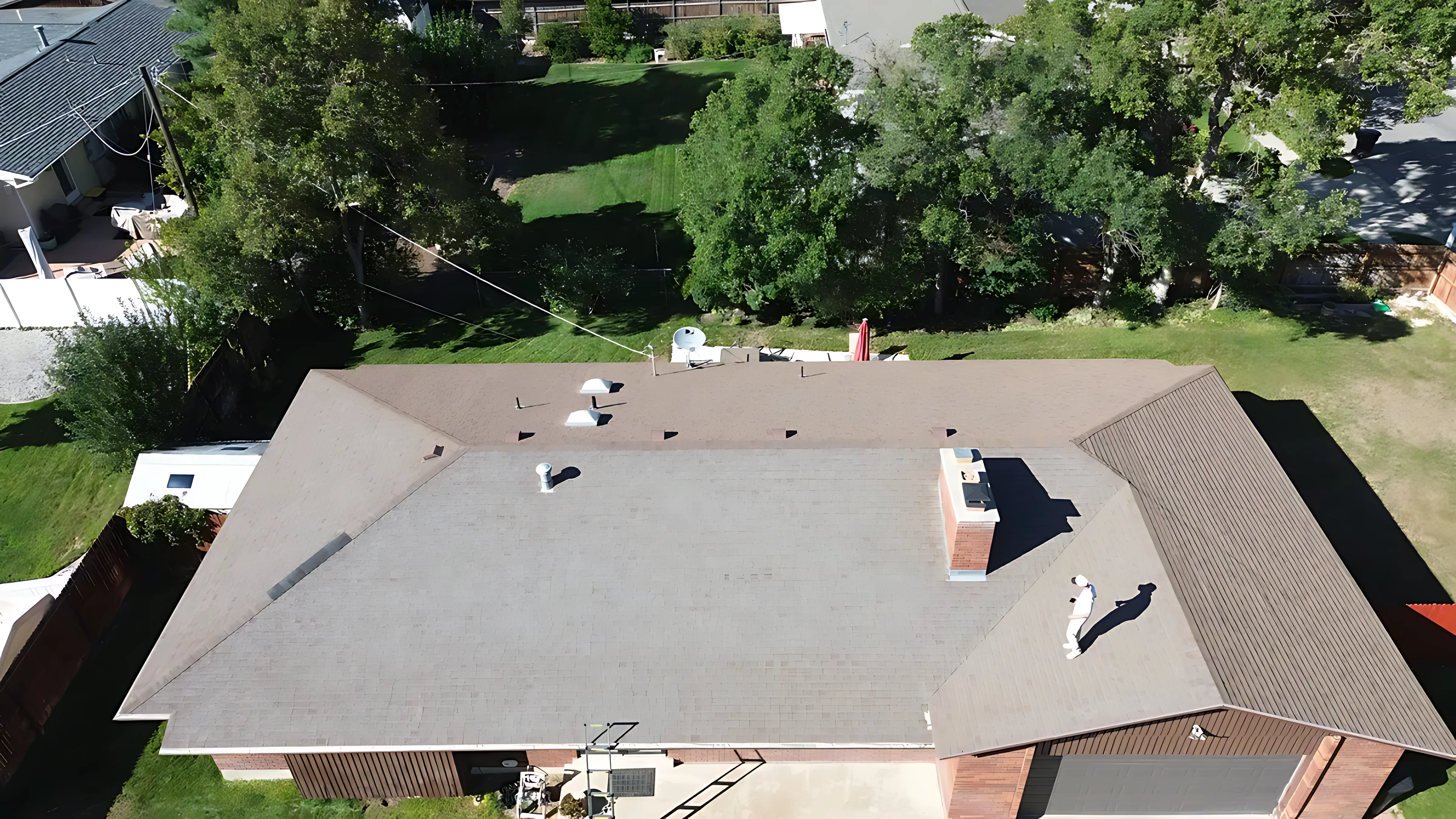 Abandoned swamp cooler unit being craned off a Utah roof during replacement