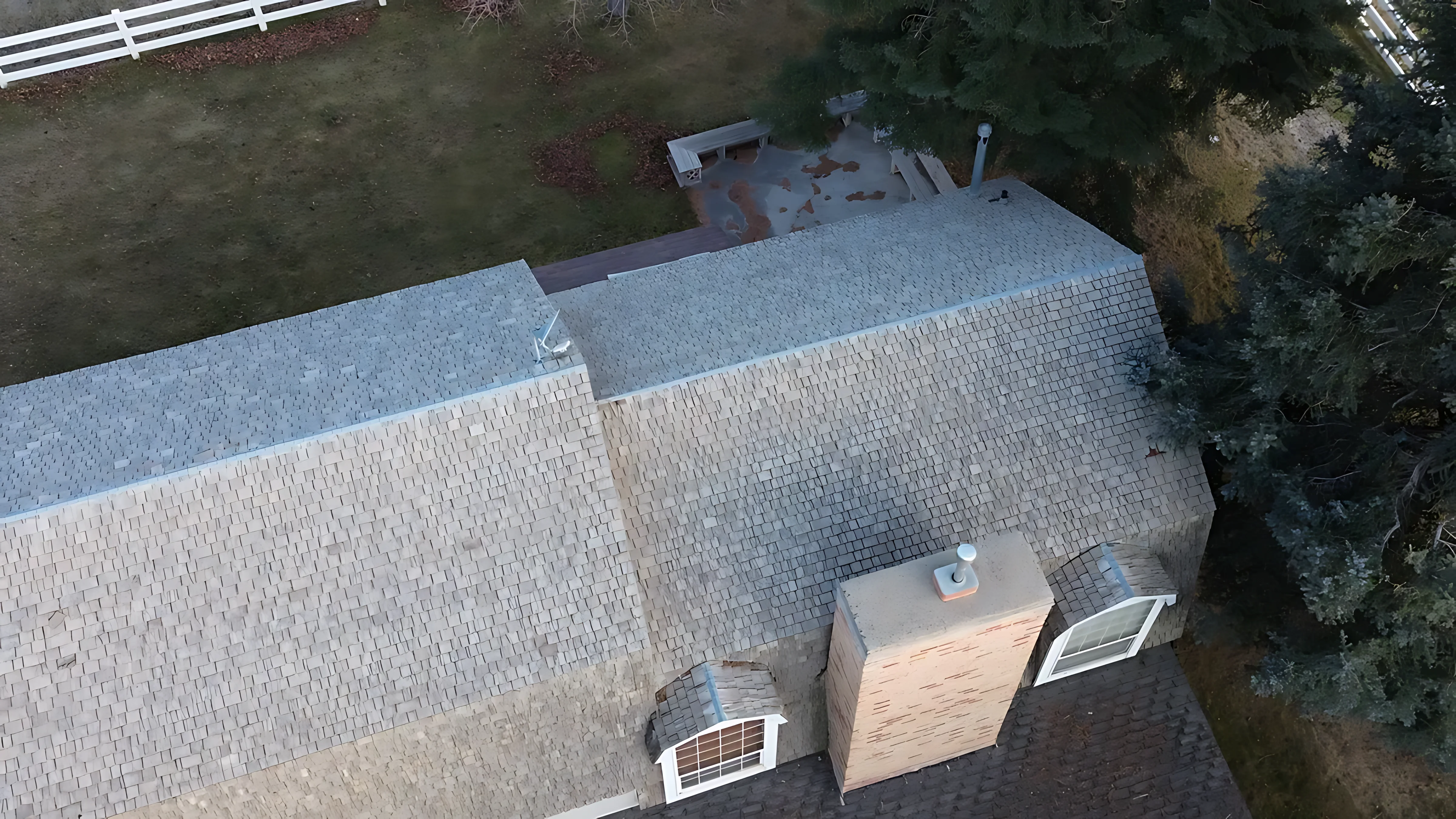 Old gutters being removed during a full roof tear-off