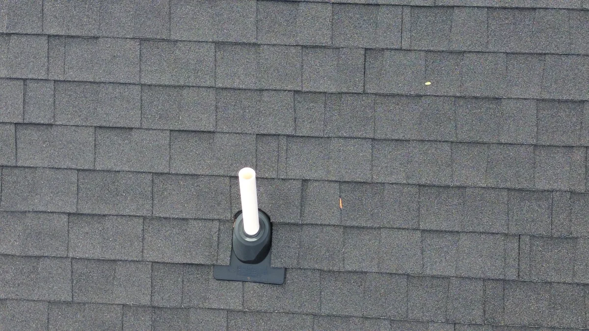 Roofing crew site overview from drone